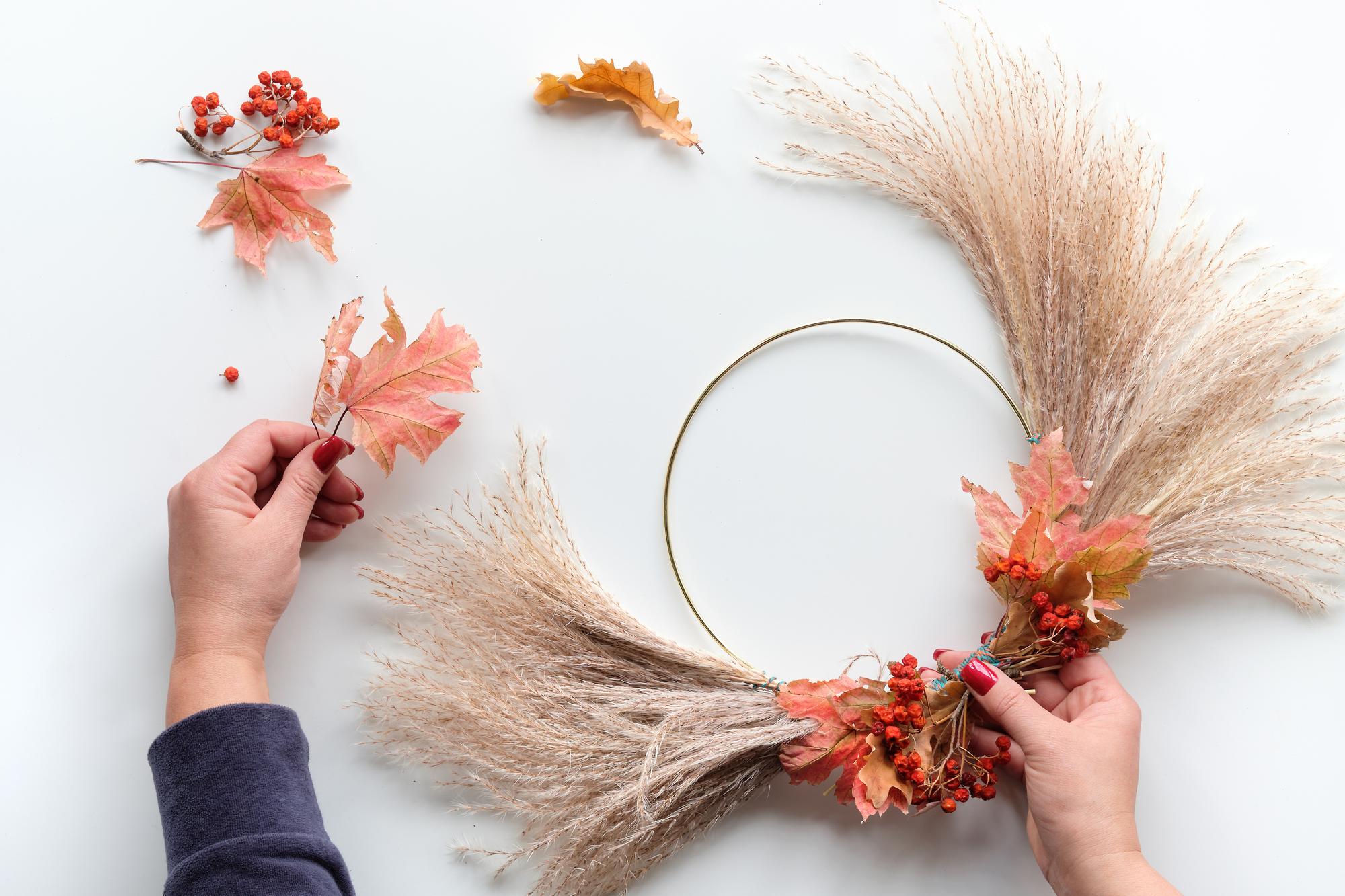 artisan hands embroidering floral motif